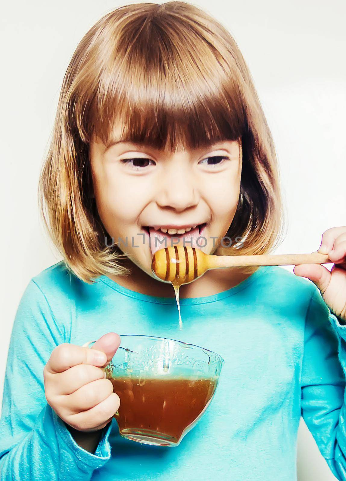 The child eats honey. Selective focus. nature. by yanadjana