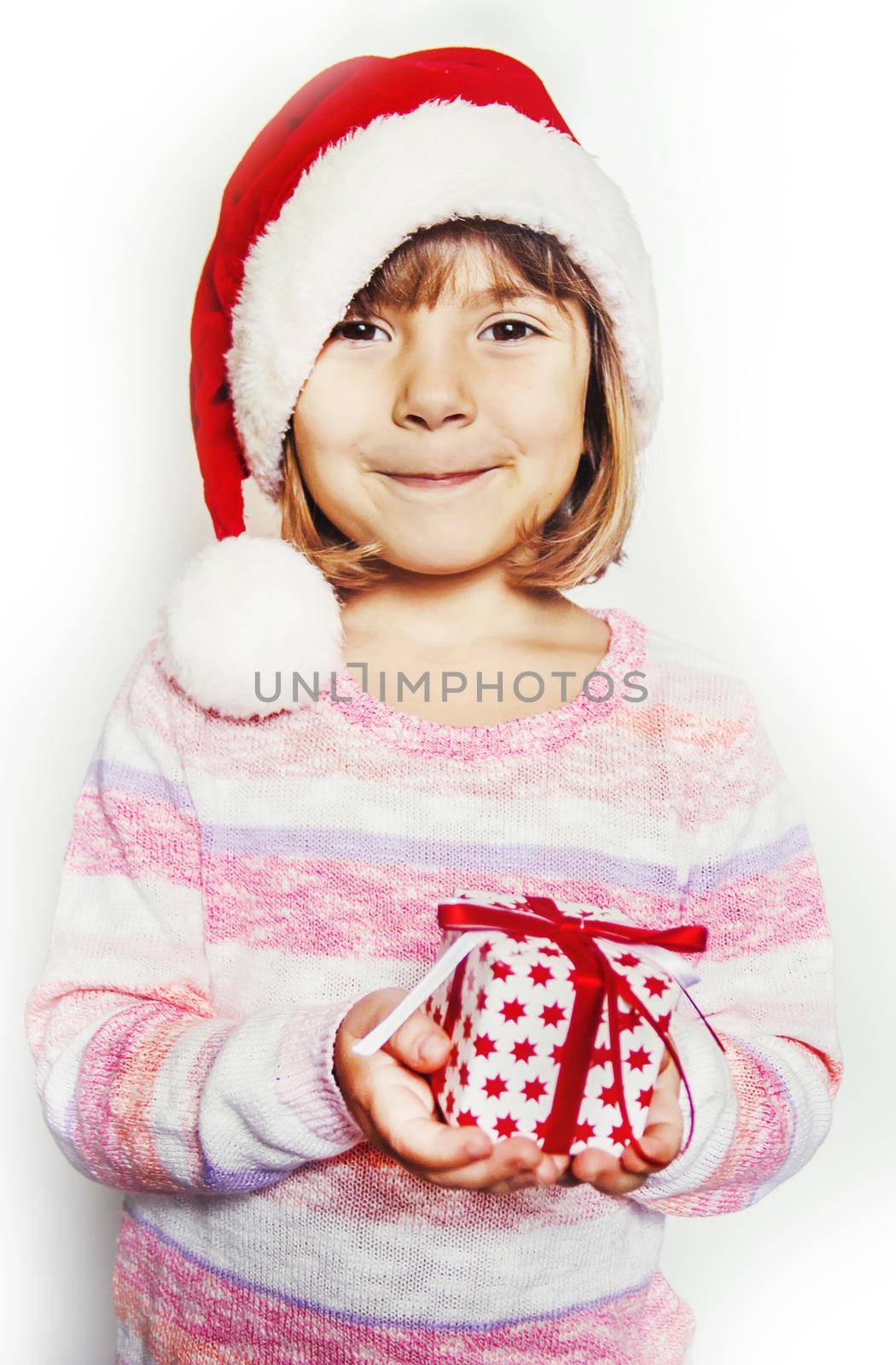 Child holds a Christmas decor and gifts on a white background. Selective focus. by yanadjana