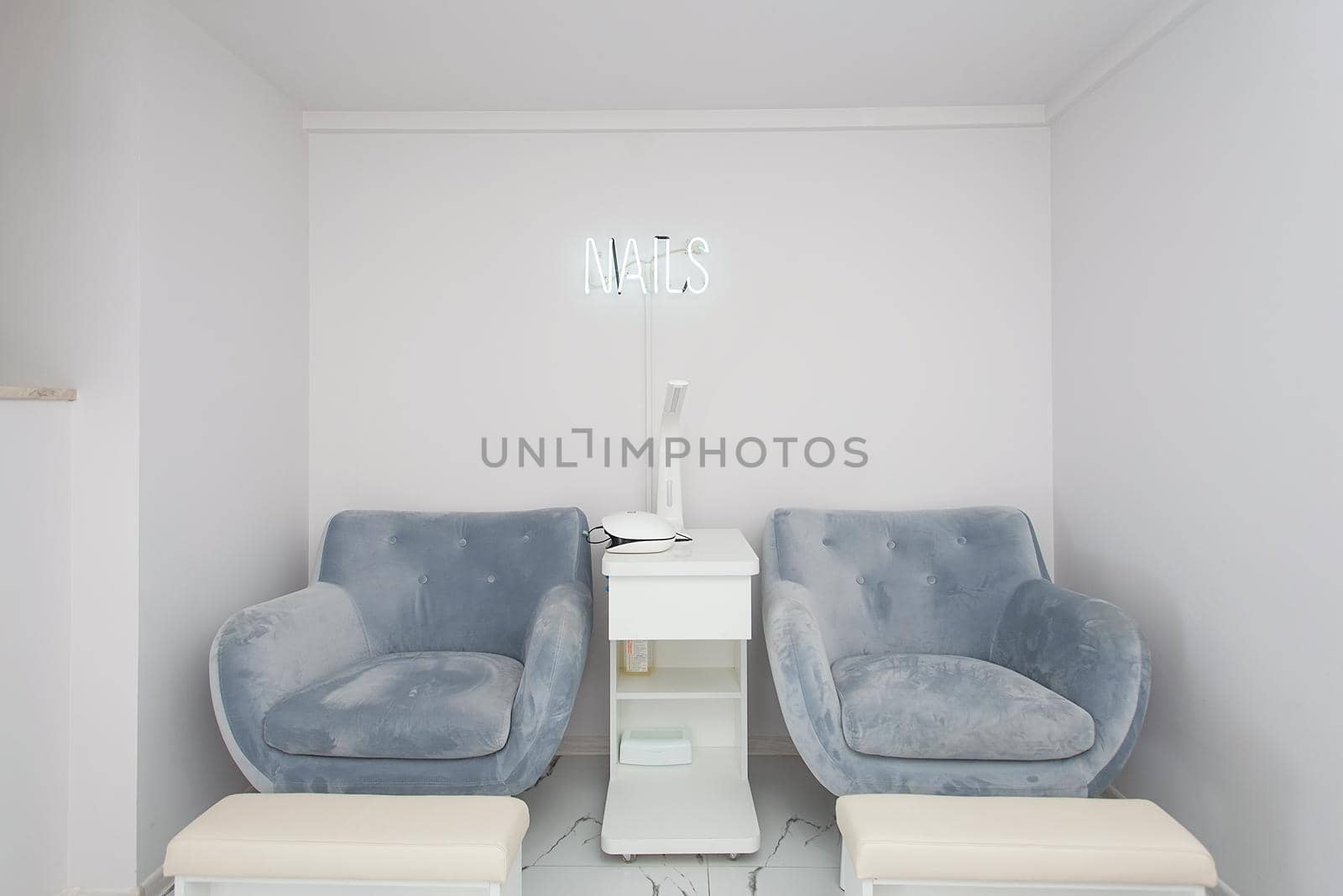 Interior of white modern manicure salon without people. Luxury work places for masters of pedicure