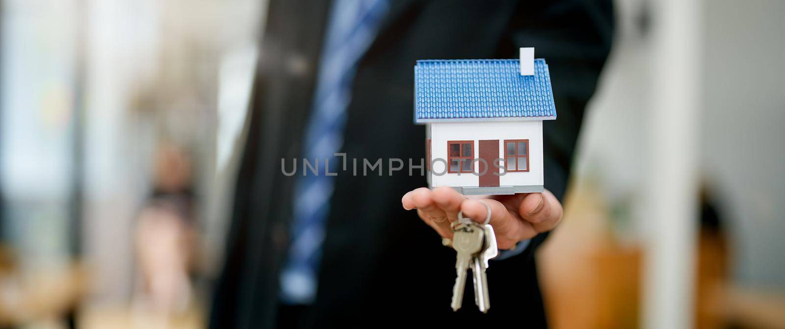 Real estate agent giving with house model and keys o buyer. banner. by nateemee