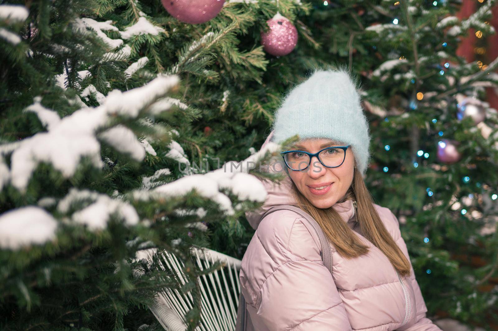 Pretty woman with fir tree. Xmas holidays, New Year or Christmas concept