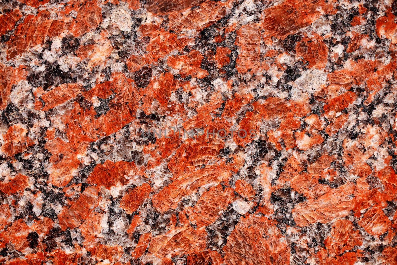 Red granite tile texture close up. Nature granite texture background. Polished decorative stone for photo design. Macro red grey granite decorative tile background may be used as a design pattern.