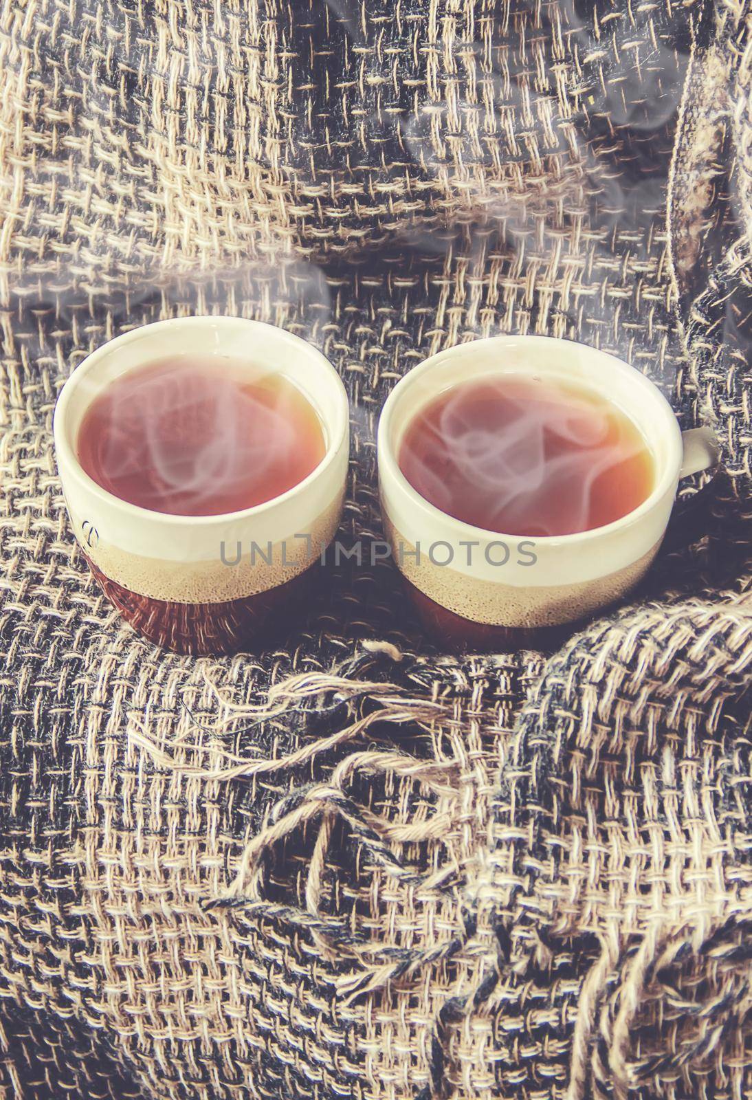 hot tea in the pot near the window. selective focus. by yanadjana