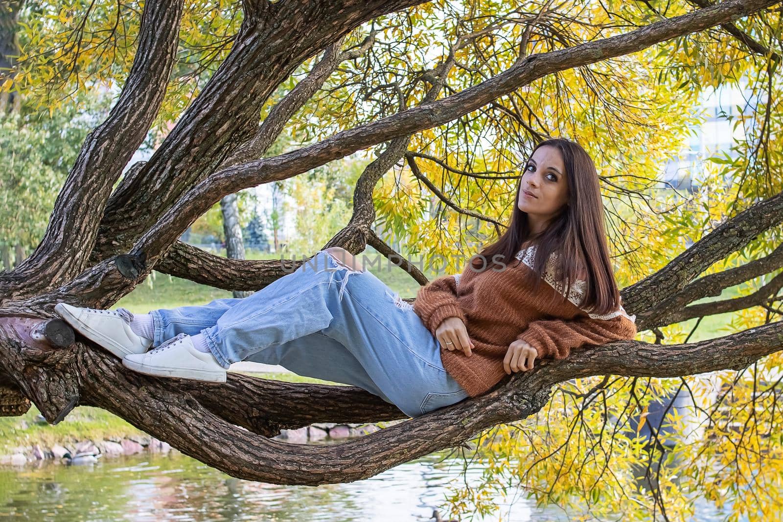 A girl is dotting on a tree branch close up