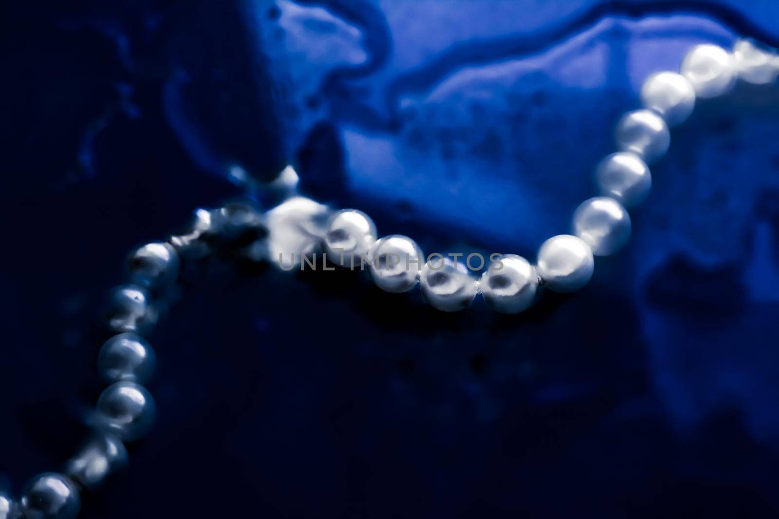 Jewelry, branding and gems concept - Coastal jewellery fashion, pearl necklace under blue water background, glamour style present and chic gift for luxury jewelery brand, holiday banner design