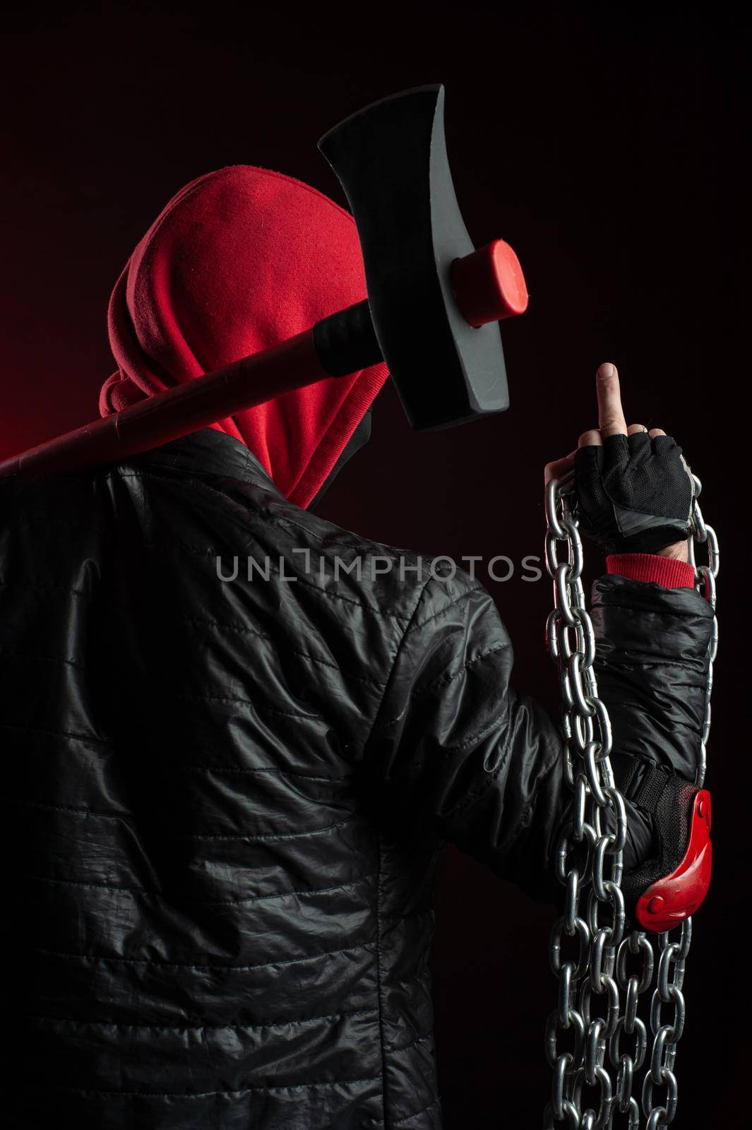 a man in a Balaclava and hoodies with an axe the image of a Protestant shows the middle finger by Rotozey