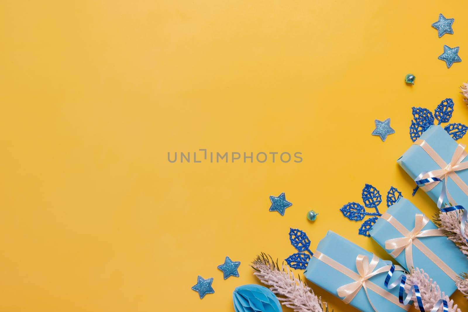 Christmas flat lay composition from gifts, paper balls and tinsel top view. Ukrainian yellow blue colors. Copy space by ssvimaliss