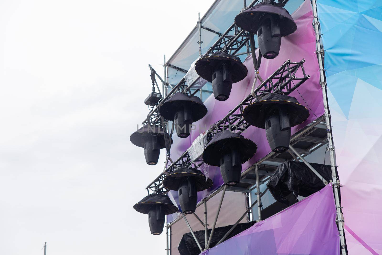 Professional lighting equipment high above an outdoor concert scene. by BY-_-BY