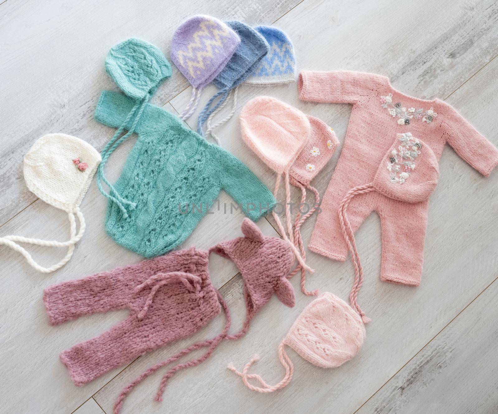 Simple knitted handmade clothes for newborn babies. topview props for photo sessions