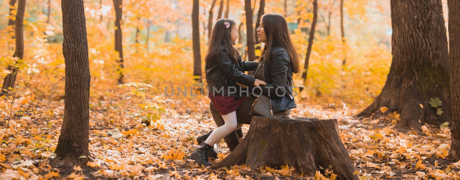 Banner little girl playing with mother in the autumn park, copy space by Satura86