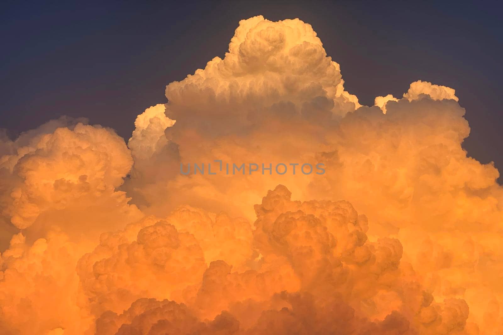 Colorful bright clouds in sunlight and in shadow at sunset