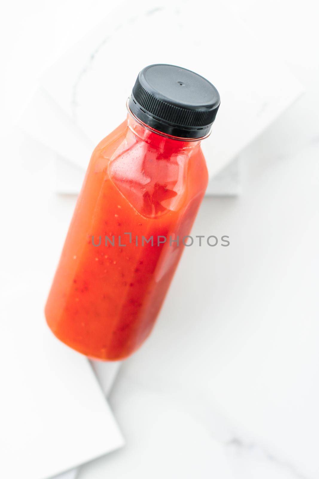 Healthy nutrition, organic drink and fasting cleanse concept - Detox red fruit smoothie juice in a bottle, diet catering delivery. Isolated on white background