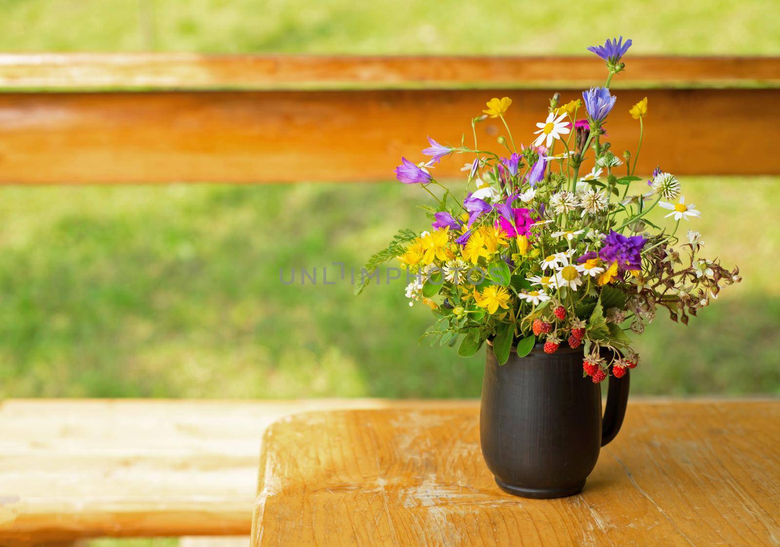 bouquet of wild flowers on a wooden background