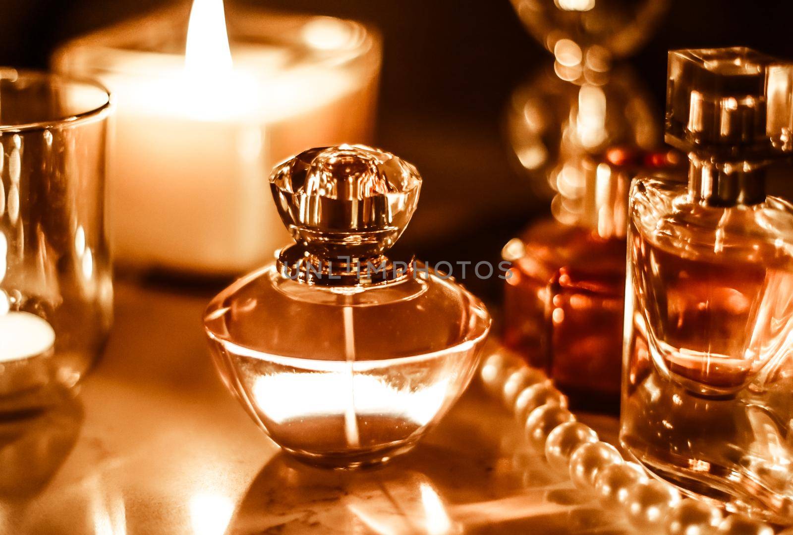 Perfumery, cosmetics branding and luxe concept - Perfume bottle and vintage fragrance on glamour vanity table at night, pearls jewellery and eau de parfum as holiday gift, luxury beauty brand present