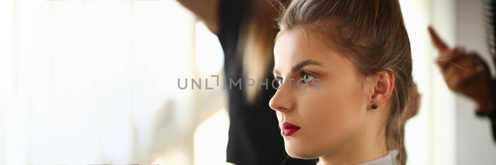 Portrait of a young woman at hairdresser. Beauty salon services and trendy haircuts concept