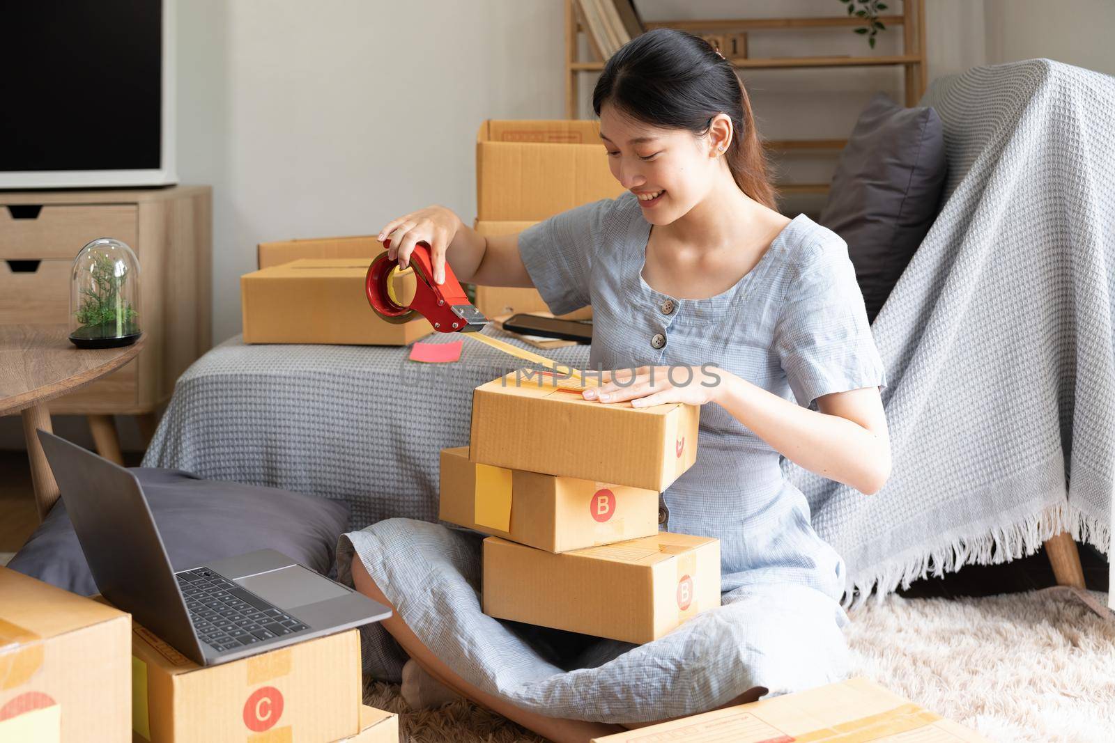 Young startup small business entrepreneur woman packing package post shipping box preparing delivery parcel , Online business, ecommerce and delivery concept by nateemee
