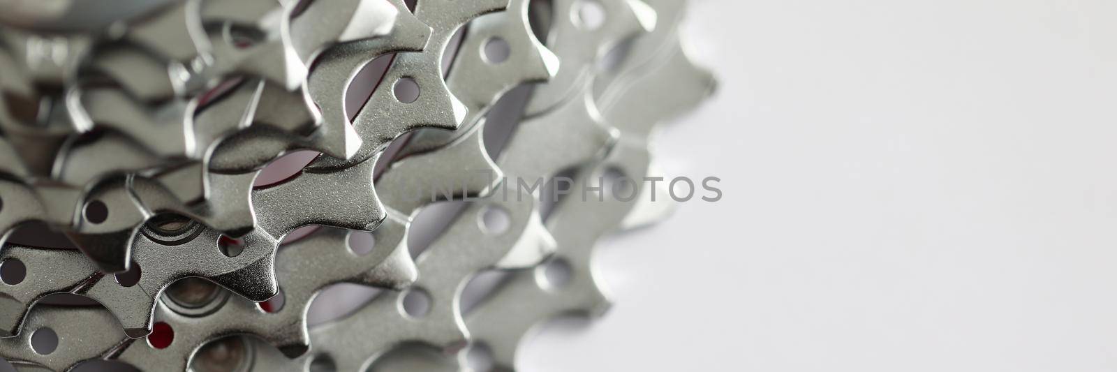 Shiny metal chrome chain cassette on iron mountain bike. Speed equipment on white background. Alloy wheel of mountain bike with chrome brake cassette and gear wheel