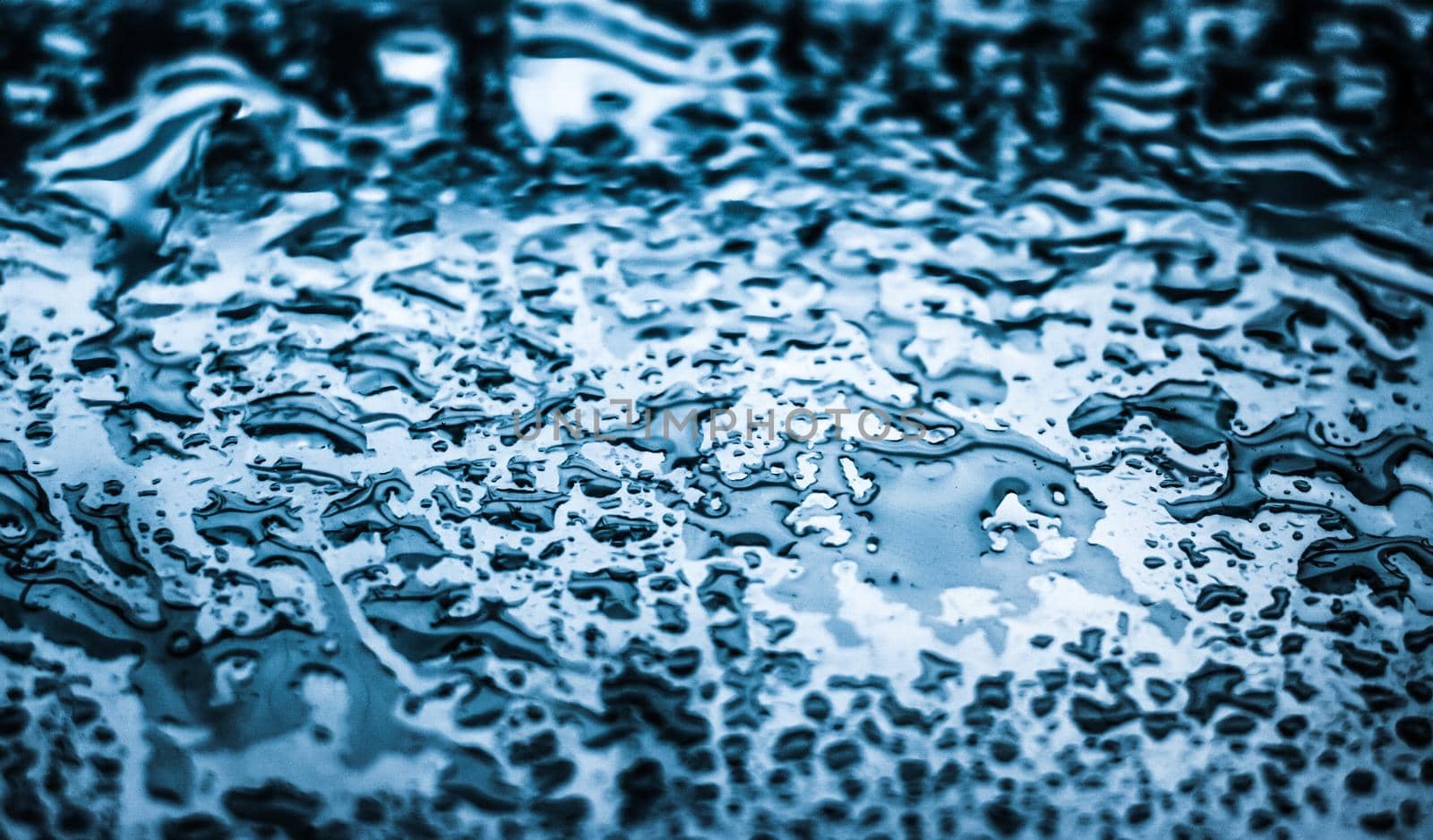 Liquid, wet and zen concept - Water texture abstract background, aqua drops on blue glass as science macro element, rainy weather and nature surface art backdrop for environmental brand design