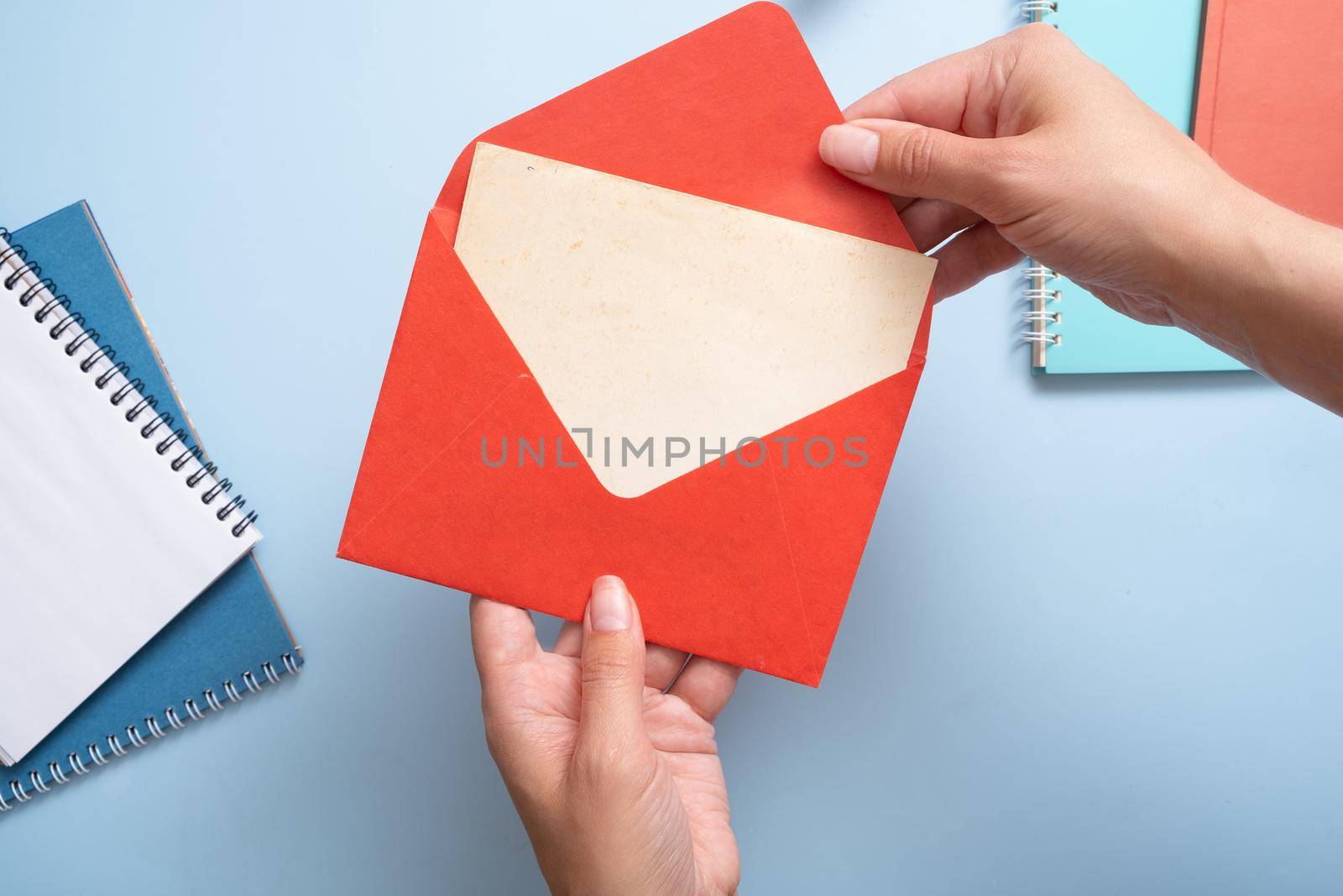Blank Vitage sheet of paper woman hands take from the envelope. Business mock up concept.