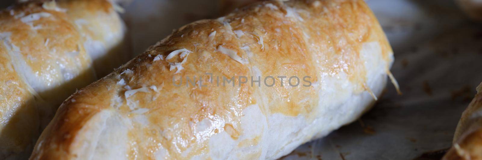 Closeup of delicious appetizing homemade buns on baking sheet. Home cooking concept