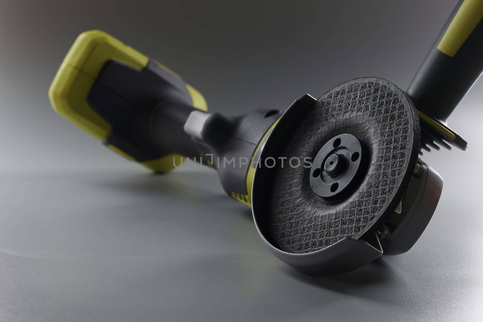 Cordless hand sander on a gray background, close-up. Electric power tools. DIY repair, construction equipment