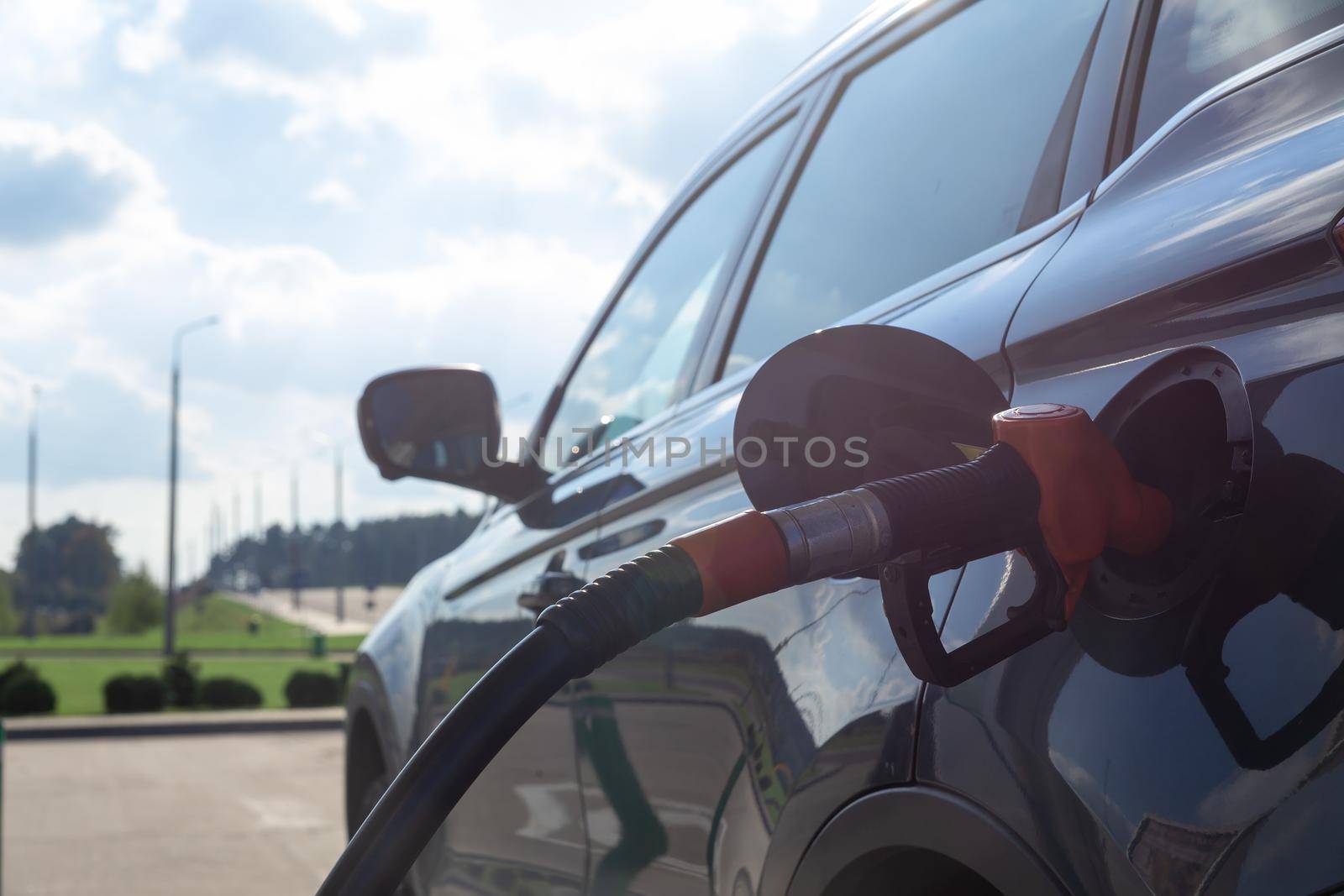 Fuel nozzle to refill fuel in car at gas station. by BY-_-BY