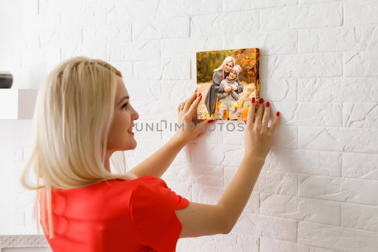 Canvas print with gallery wrap. woman hangs autumn photography, photocanvas.