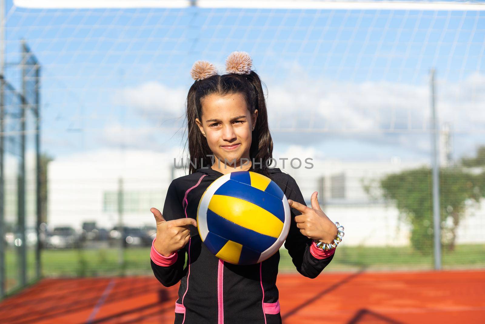 little girl with a volleyball ball.