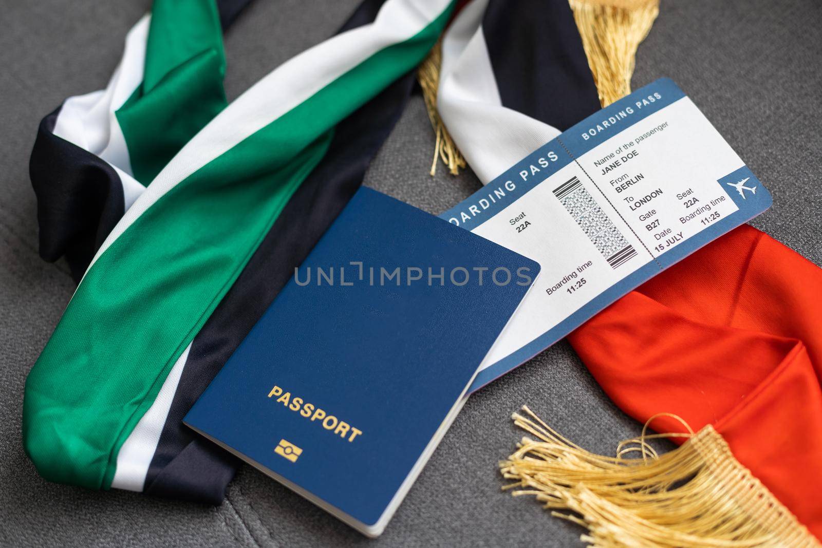 Passport of United Arab Emirates with national flag on the top of an gray background.