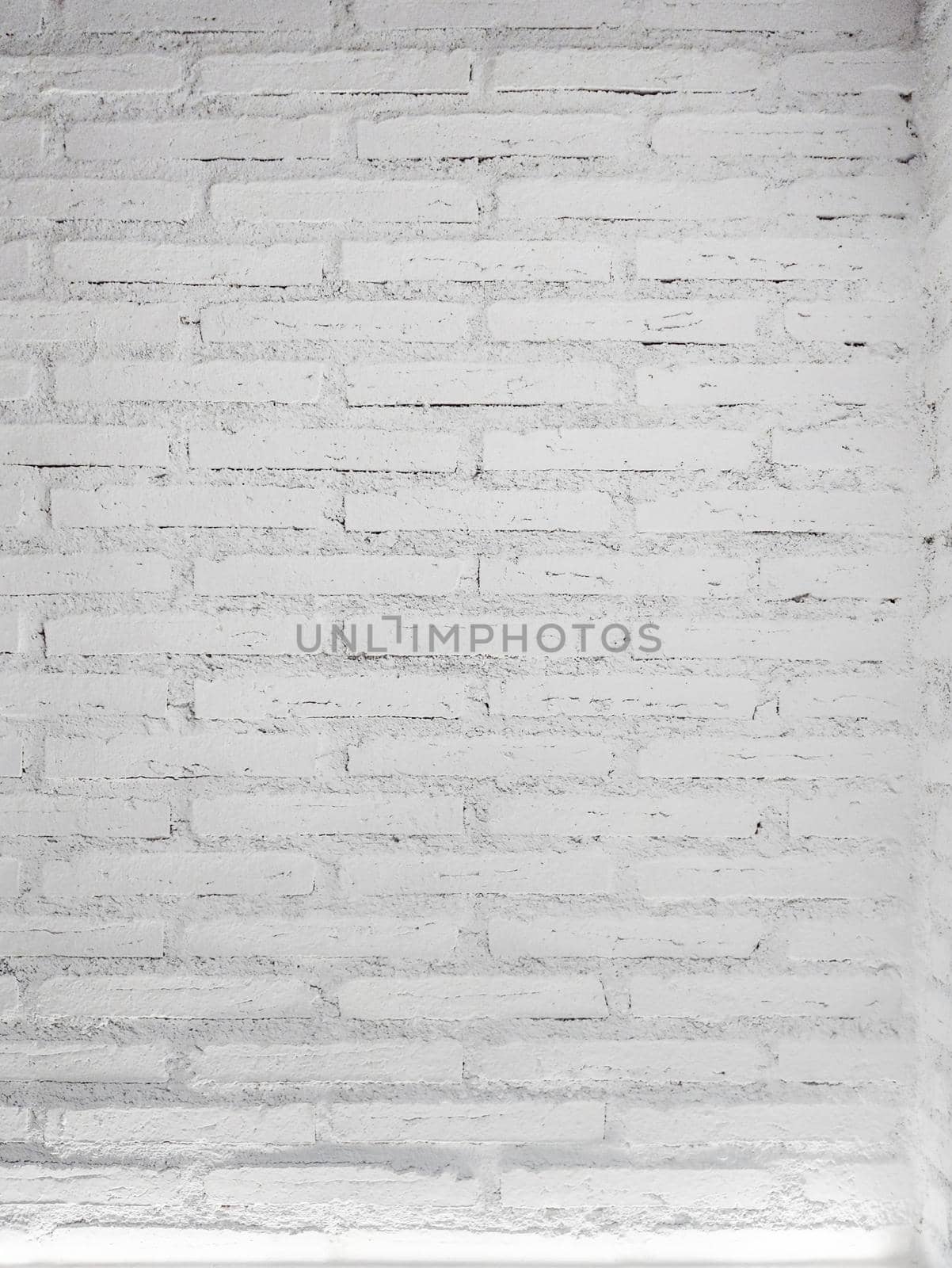 White brick wall background with a light. vertical size.