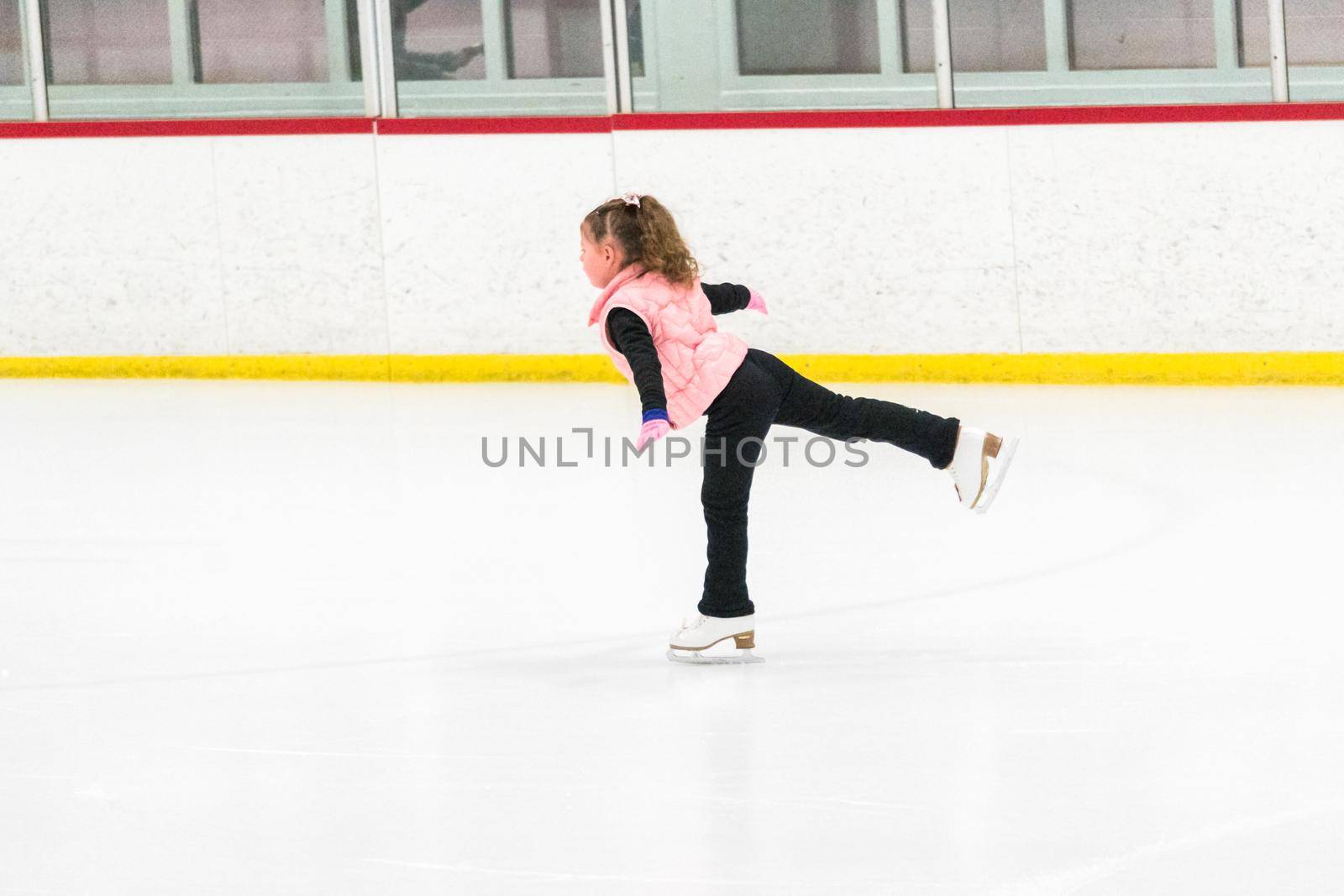 Little skater practicing her elements at the morning figure skating practice.