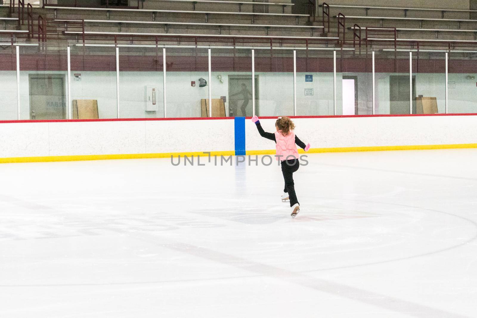 Little skater practicing her elements at the morning figure skating practice.