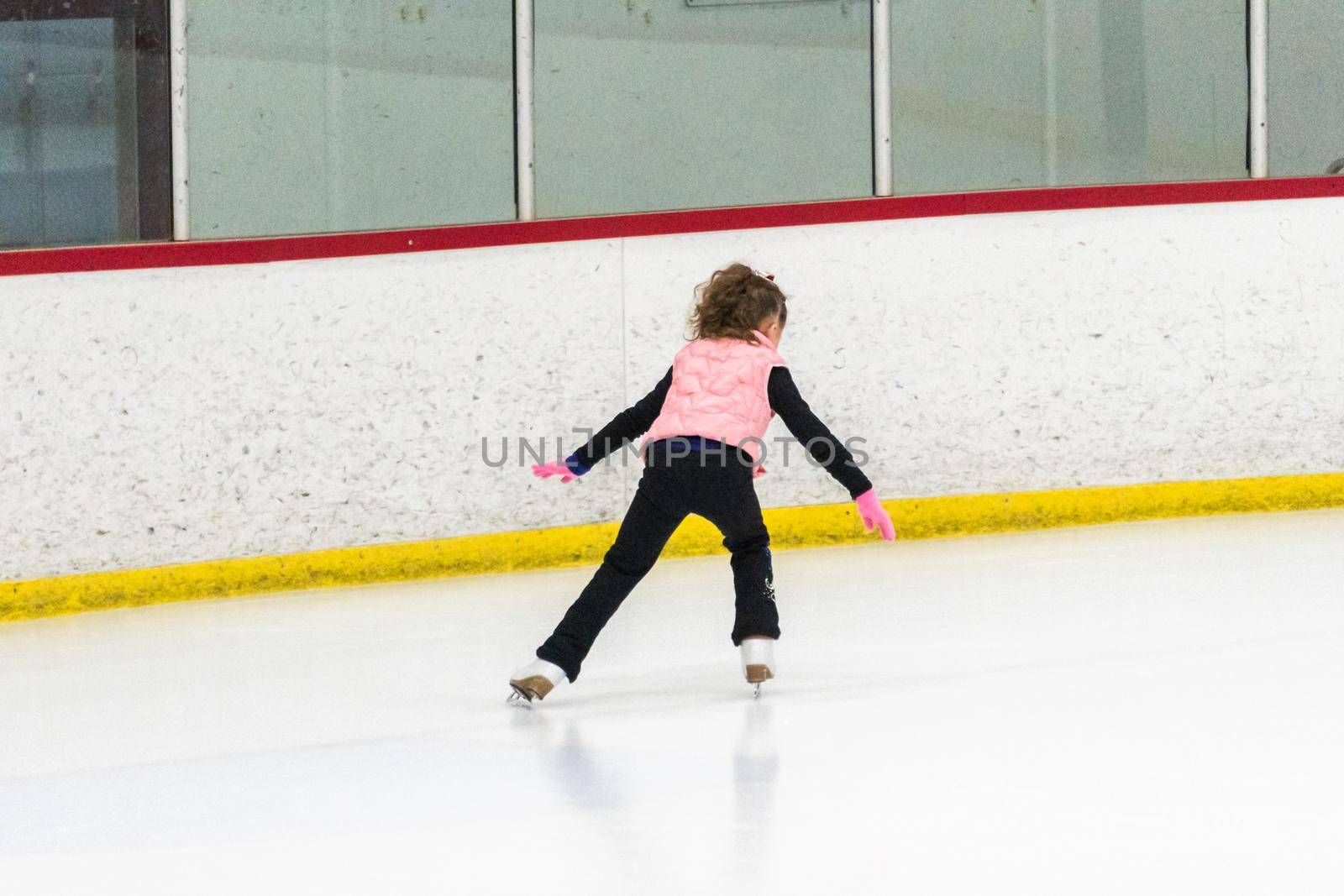 Little skater practicing her elements at the morning figure skating practice.