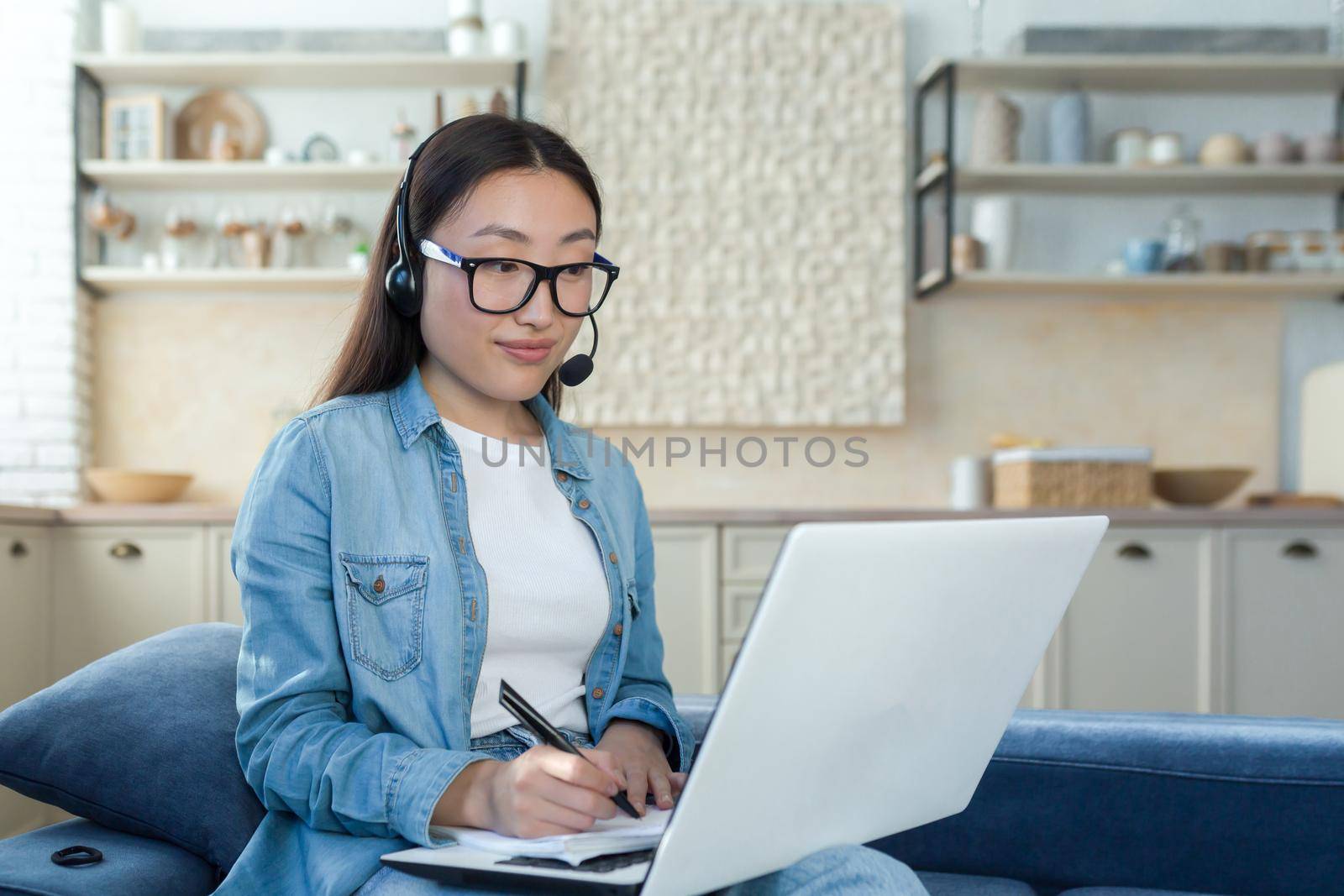 Young asian woman working from home remotely online, businesswoman using headset and laptop for video call, woman working in tech support and customer service by voronaman