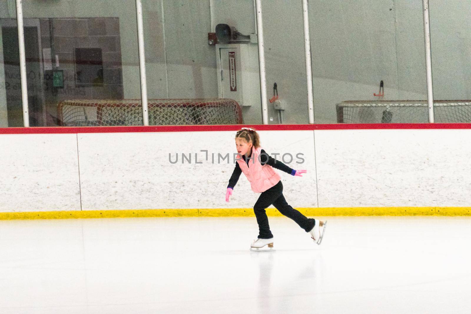 Little skater practicing her elements at the morning figure skating practice.