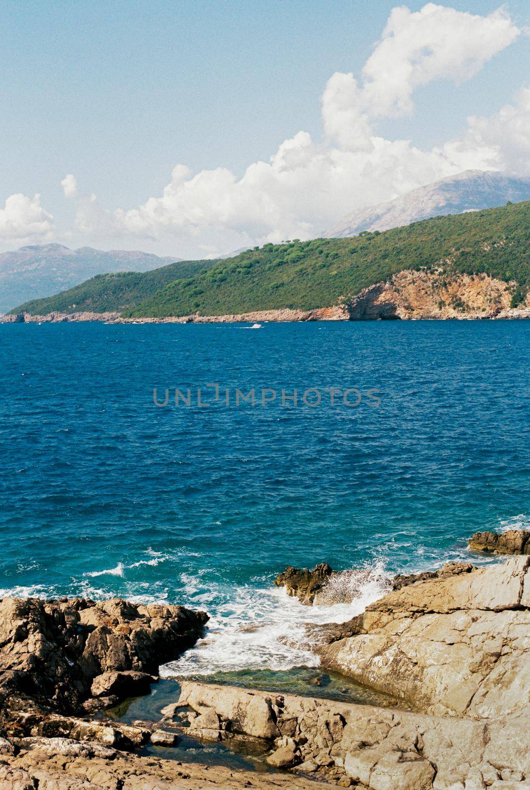 View from the rocks to the blue sea and mountains. High quality photo