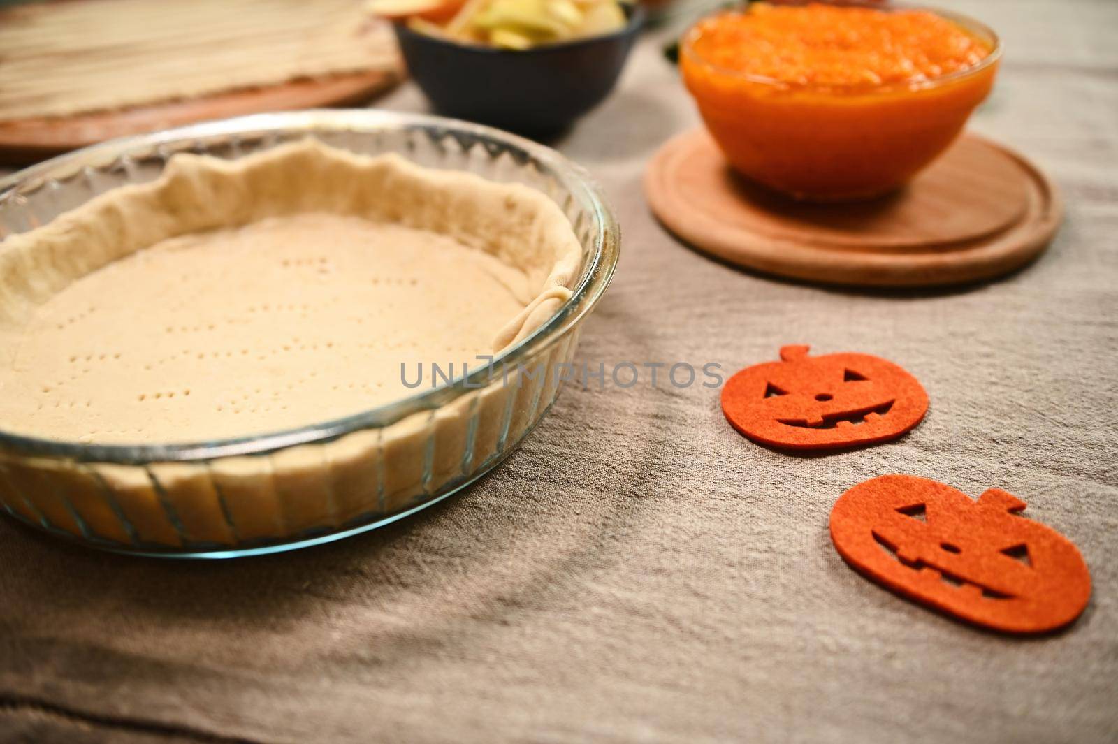 Fresh raw ingredients for making traditional pumpkin classic pie with crispy crust. Thanksgiving Day. Halloween concept by artgf