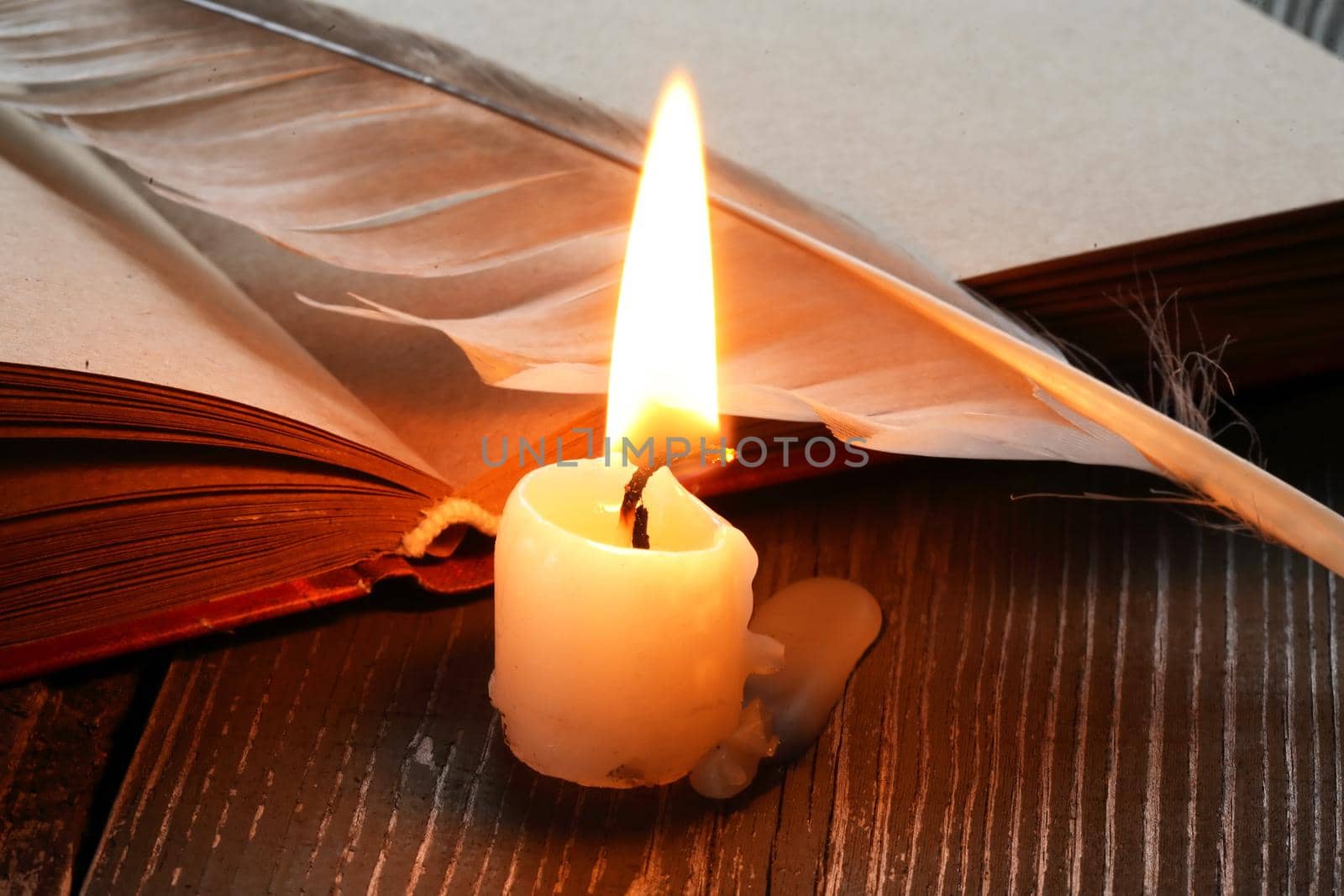 Candle Near Book And Feather by kvkirillov