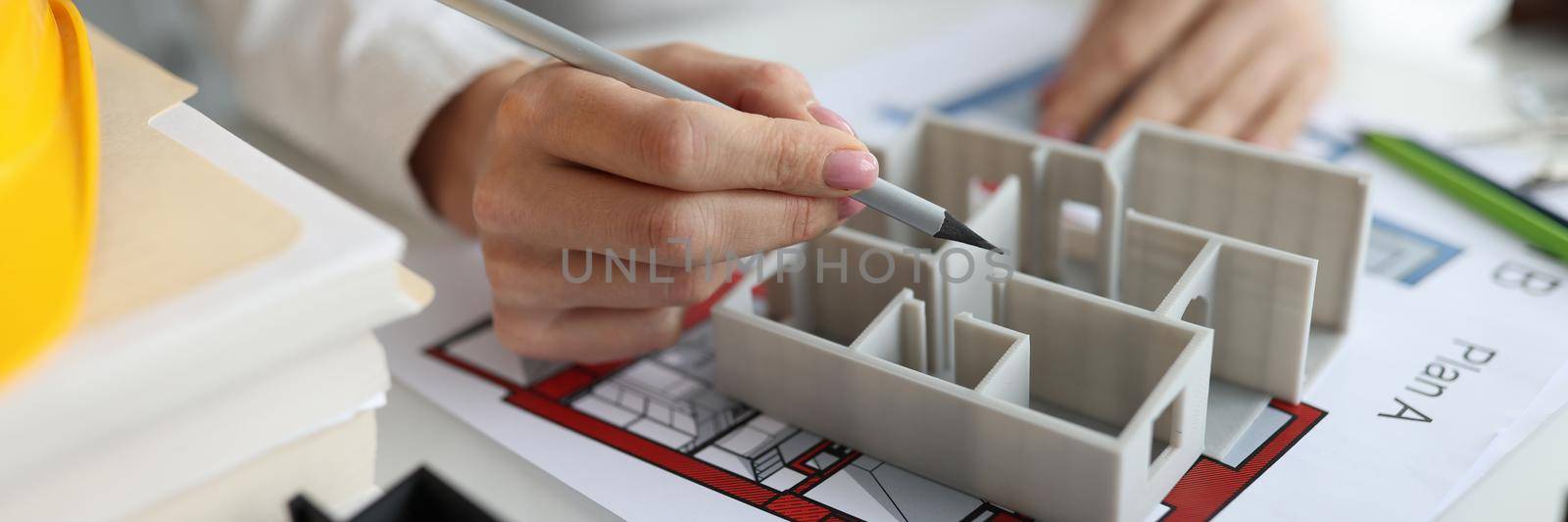 Designer architect shows layout of house. Sample home construction plan on office desk