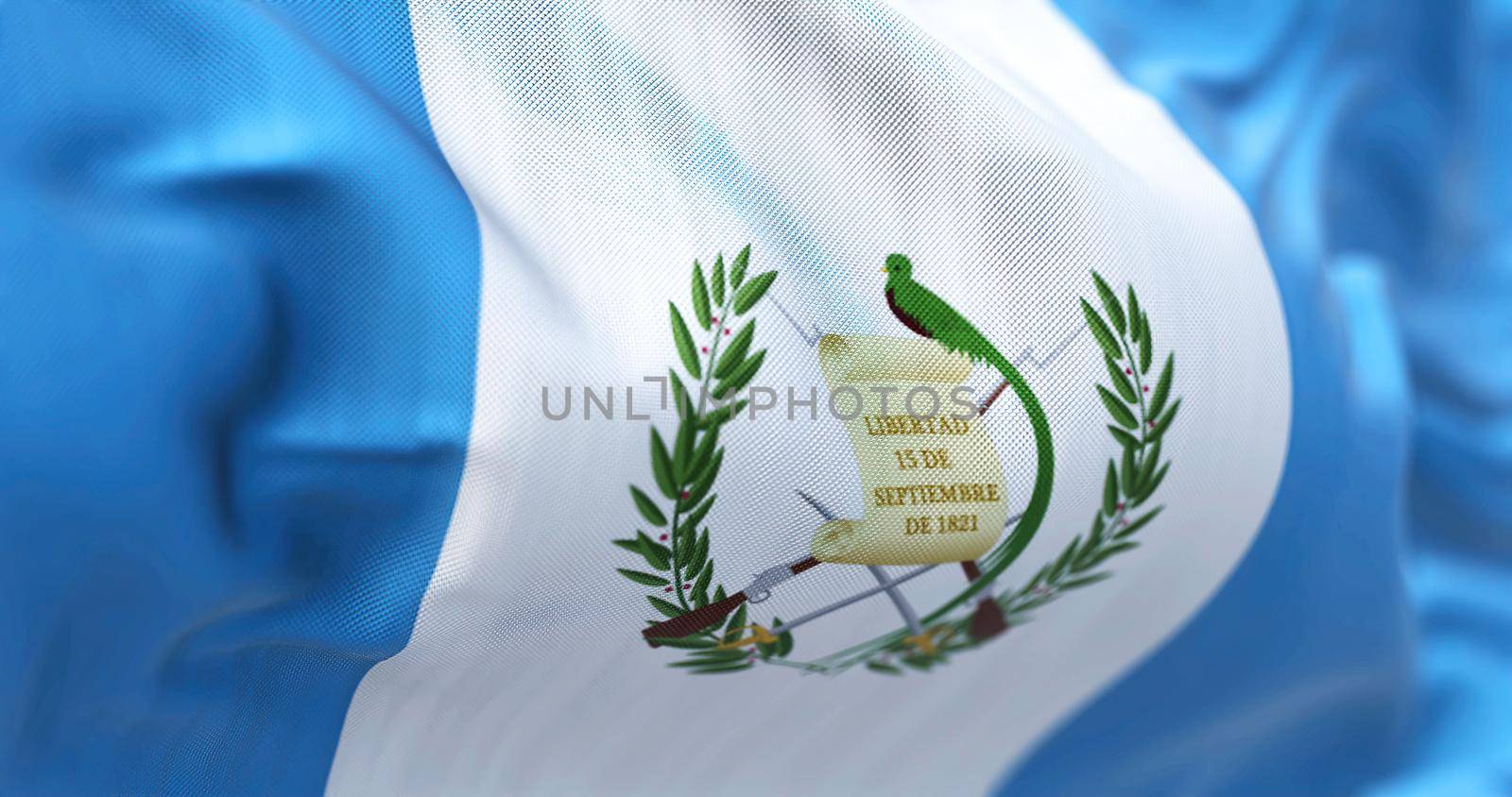 Close-up view of the Guatemala national flag waving in the wind. The Republic of Guatemala is a State of Central America. Fabric textured background. Selective focus