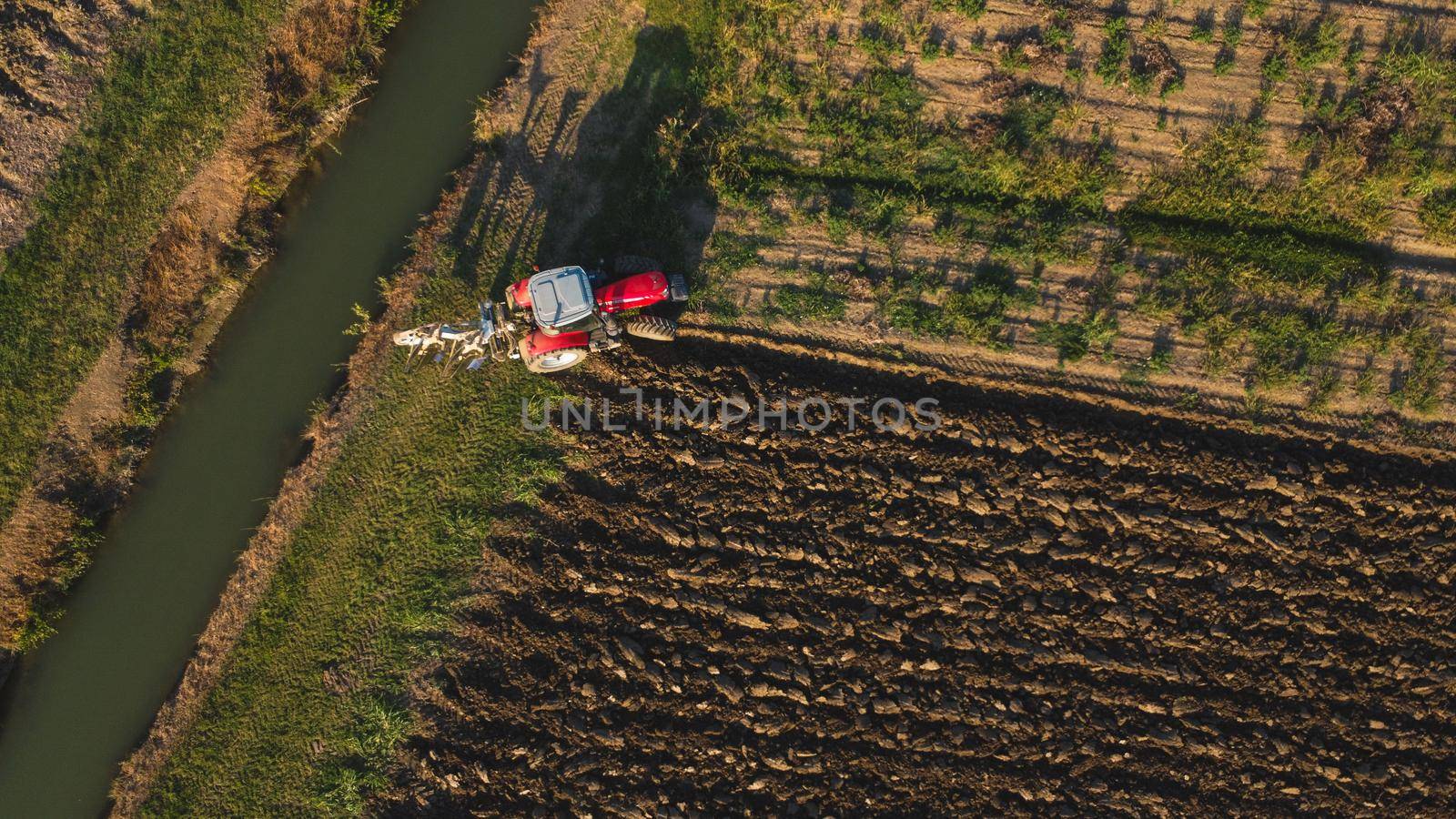 Monitcelli, Italy PC - September 2022 Tractor plowing the land in the fields by verbano