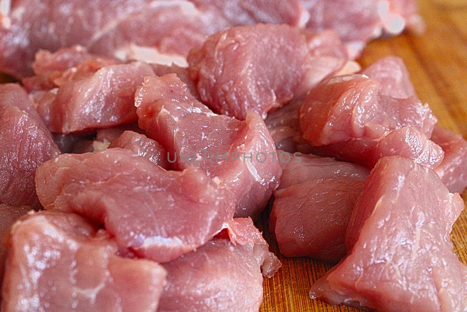 Pieces of fresh red meat on a wooden board. High quality photo