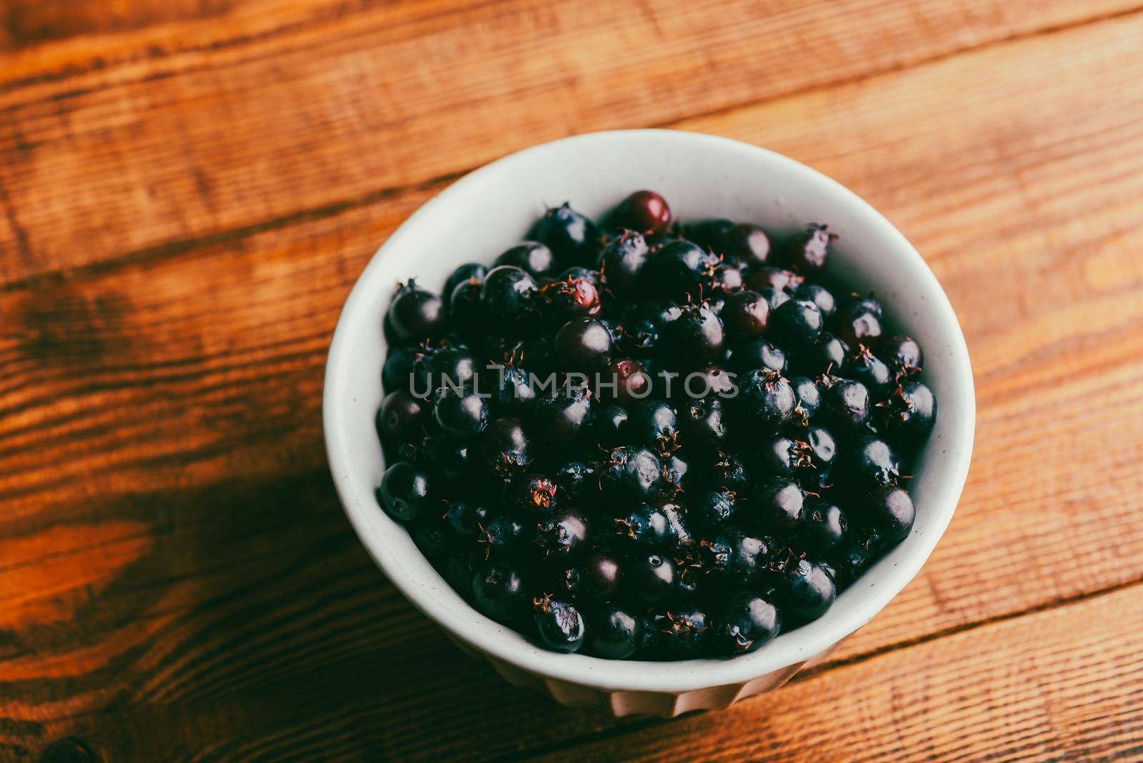 Ripe Purple Berries of Shadbush in Bowl by Seva_blsv