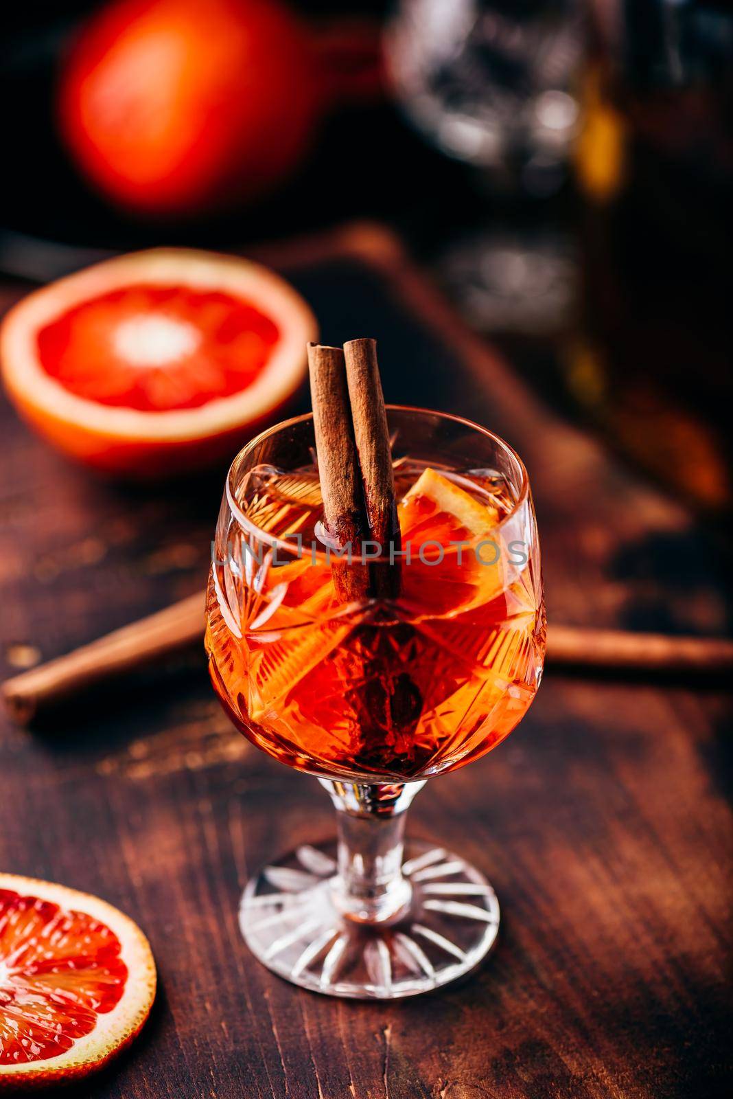 Blood orange whiskey sour cocktail with aged bourbon, blood orange juice, cherry syrup and cinnamon