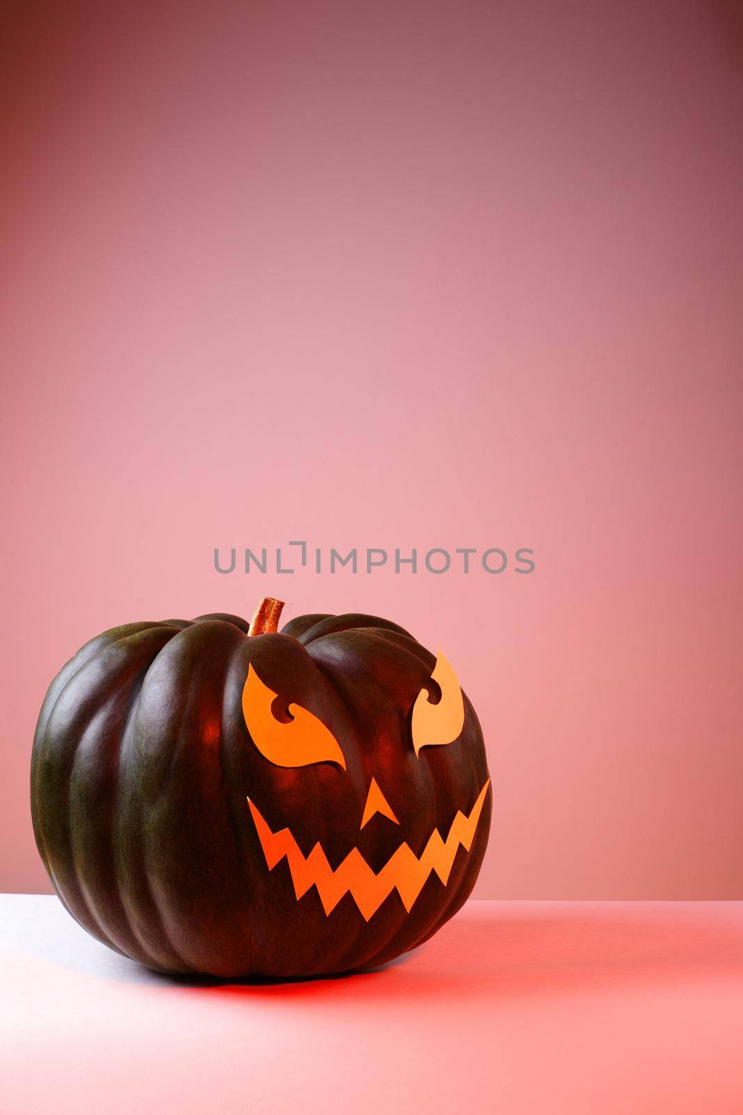 Halloween Pumpkin with Paper Cut Scary Face on a White Background. Jack Halloween. Smile Jack Pumpkin. Copy space
