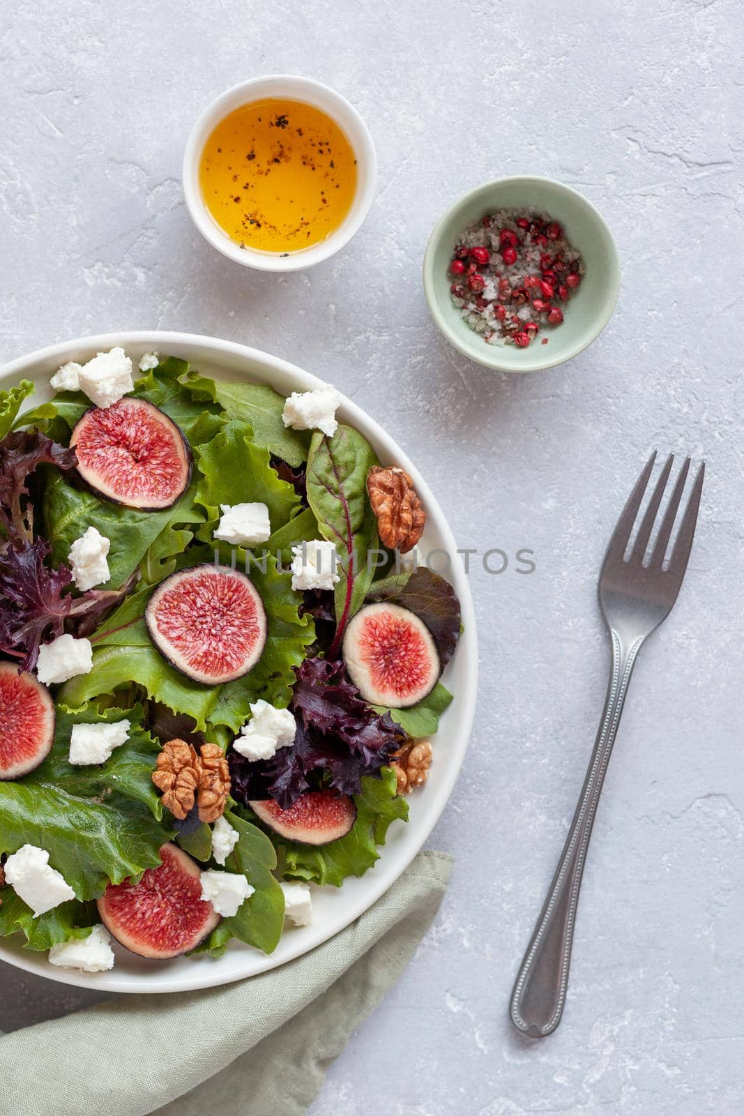 portion of fig, salad leaves, feta and walnuts salad, overhead