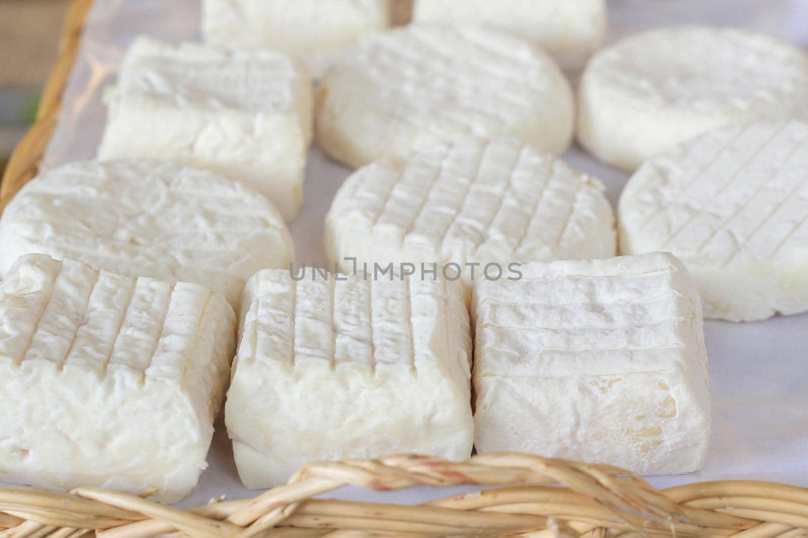 fresh goat homemade cheese at the market, closeup photo