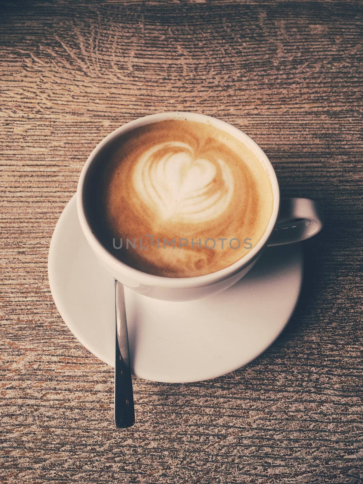 Morning drink, breakfast and rustic style concept - Cup of hot cappuccino in a cafeteria, coffee on a wooden table in cafe