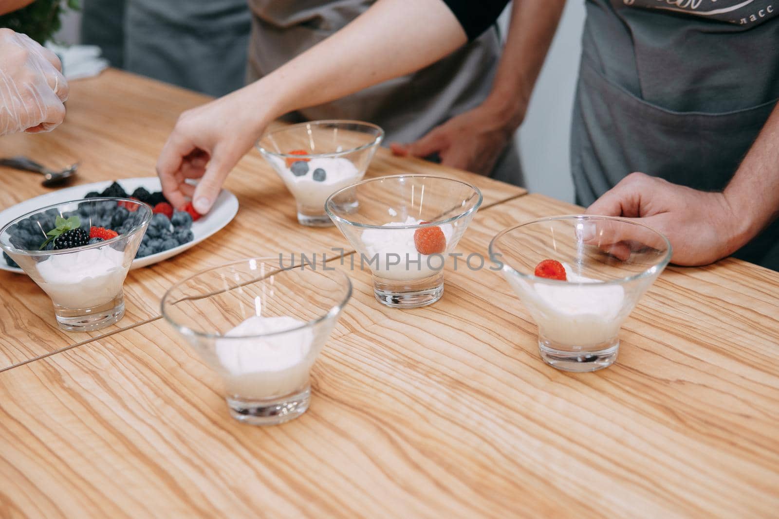 Dessert with wild berries: blackberries, blueberries, raspberries. Cream with berries at a cooking class. Cooking at home, home-made food.