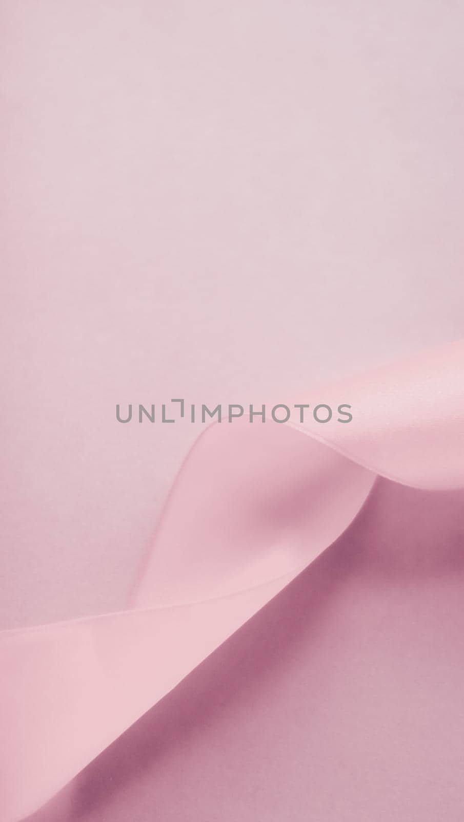 Branding, holidays and luxe brands concept - Abstract silk ribbon on blush pink background, exclusive luxury brand design for holiday sale product promotion and glamour art invitation card backdrop